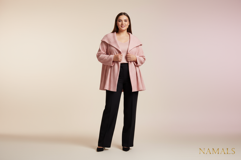 A realistic 4K studio photo of a confident woman weighing around 70 kg, modeling a pink jacket and black pants for the Namals fashion brand. The image should have a clean, elegant background (white or soft pastel), with professional studio lighting that highlights the fabric’s texture and color. The model looks natural, poised, and stylish — reflecting modern, body-positive fashion. The outfit should appear high-quality, feminine, and luxurious, consistent with the Namals aesthetic. Full-body shot, ultra-re